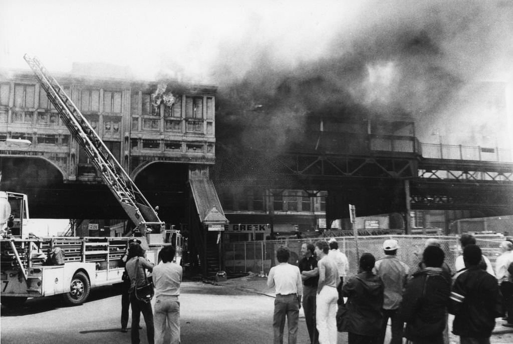 #19 People watch a three-alarm fire at the MBTA Station on Dover Street in the South End of Boston, May 6, 1962.
