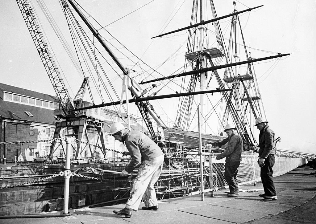 #134 Workers erect fence around the Charlestown Navy Yard in Boston to protect visitors while the USS Constitution is in dry dock undergoing repairs on December 10, 1963.