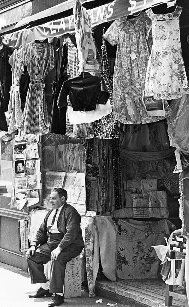 #141 Benjamin Clayman sits outside his 45-year-old dry goods store at 96 Salem St. in Boston’s North End on May 21, 1963.