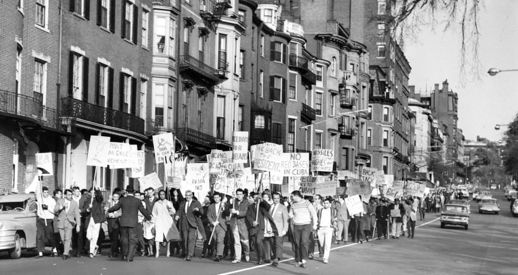 #162 Cuban refugees and their supporters march down Beacon Street in Boston during a demonstration to display their support of the U.S. government in the crisis in Cuba on Oct. 28, 1962.