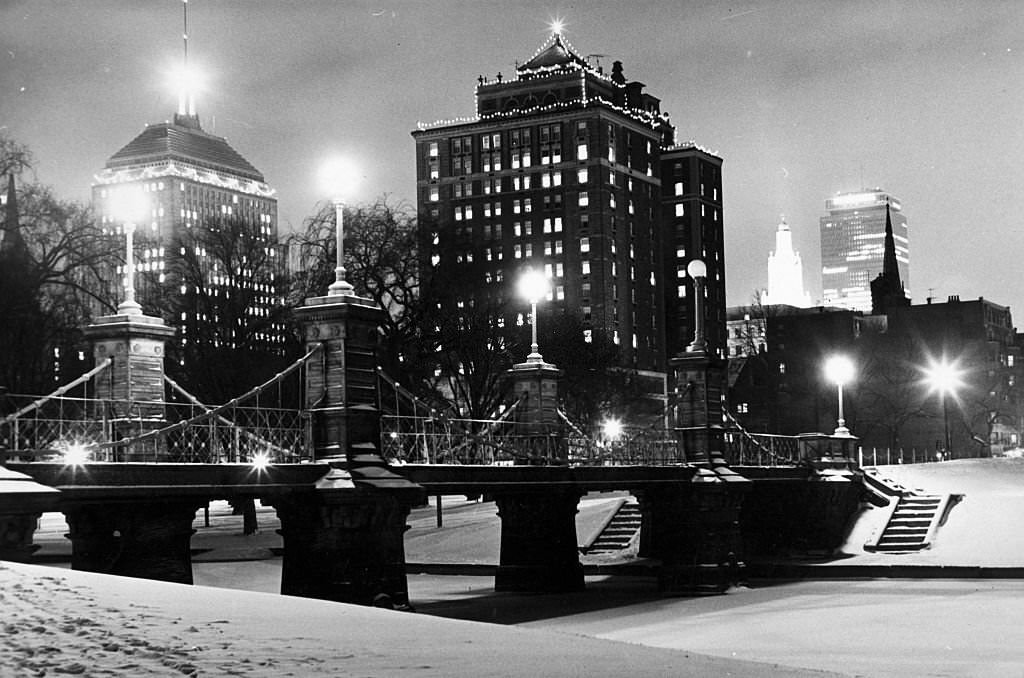 #174 Snow covers the Public Garden in Boston at night on Dec. 1,1966. The Berkeley Building and Prudential Tower can be seen in the background.