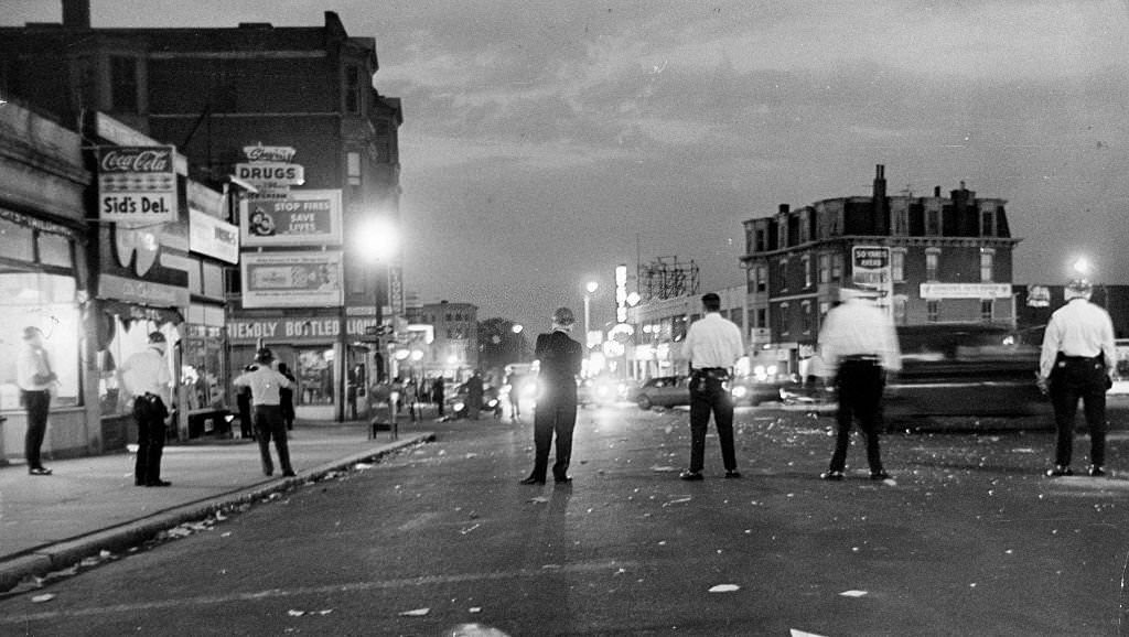 #188 Police stand in the street during a riot in the Roxbury neighborhood of Boston on June 1, 1967.