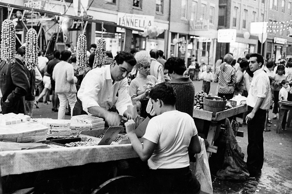#195 A vendor sells a boy peanuts at the Hanover Street Market in Boston’s North End on Aug. 11, 1967.
