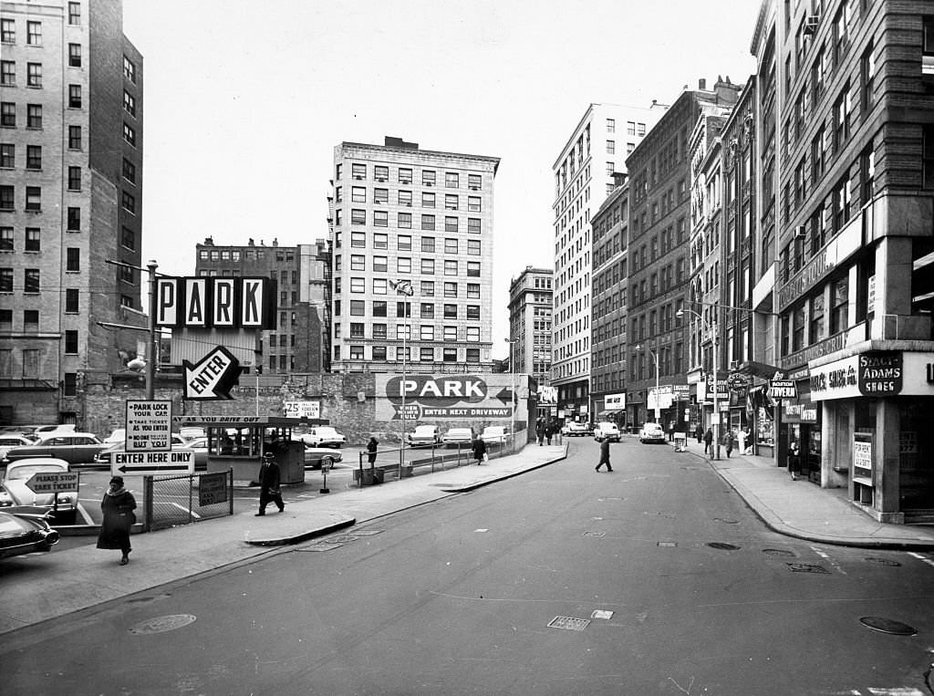 #28 Pedestrians walk around the former “Newspaper Row” on Boston’s Washington Street on Nov. 29, 1961.