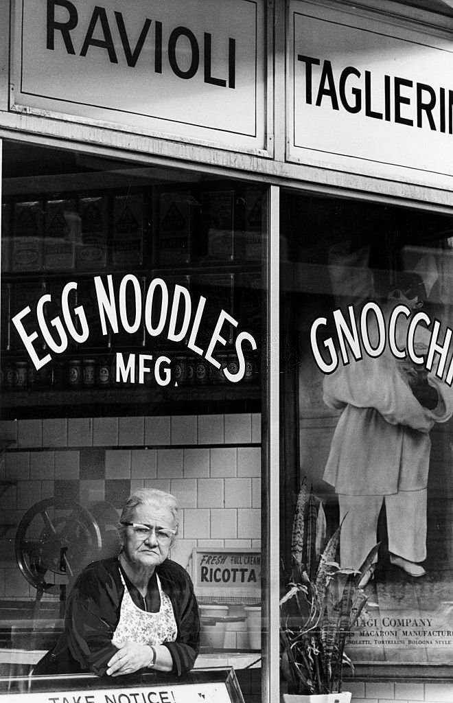 #216 Mrs. Amalia Biagi in the window of her shop in Boston’s North End on June 1, 1968.