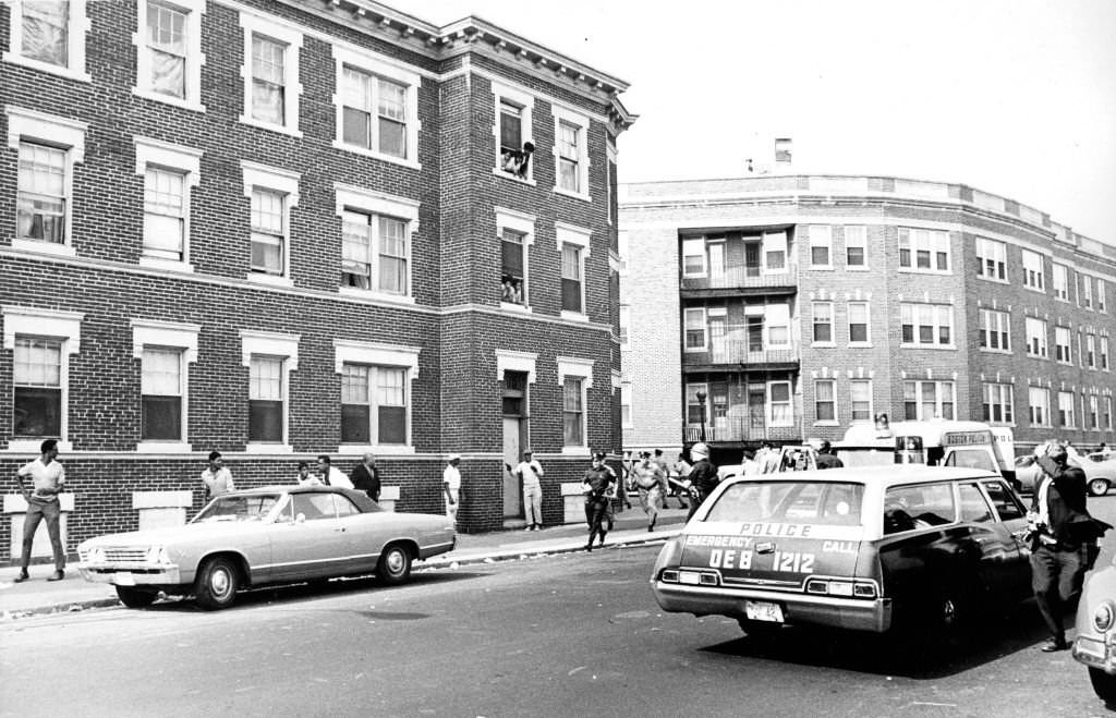 #226 Boston Police officers race toward a disturbance near the Jeremiah Burke High School on Washington Street in the Dorchester neighborhood of Boston on Sep. 25, 1968.
