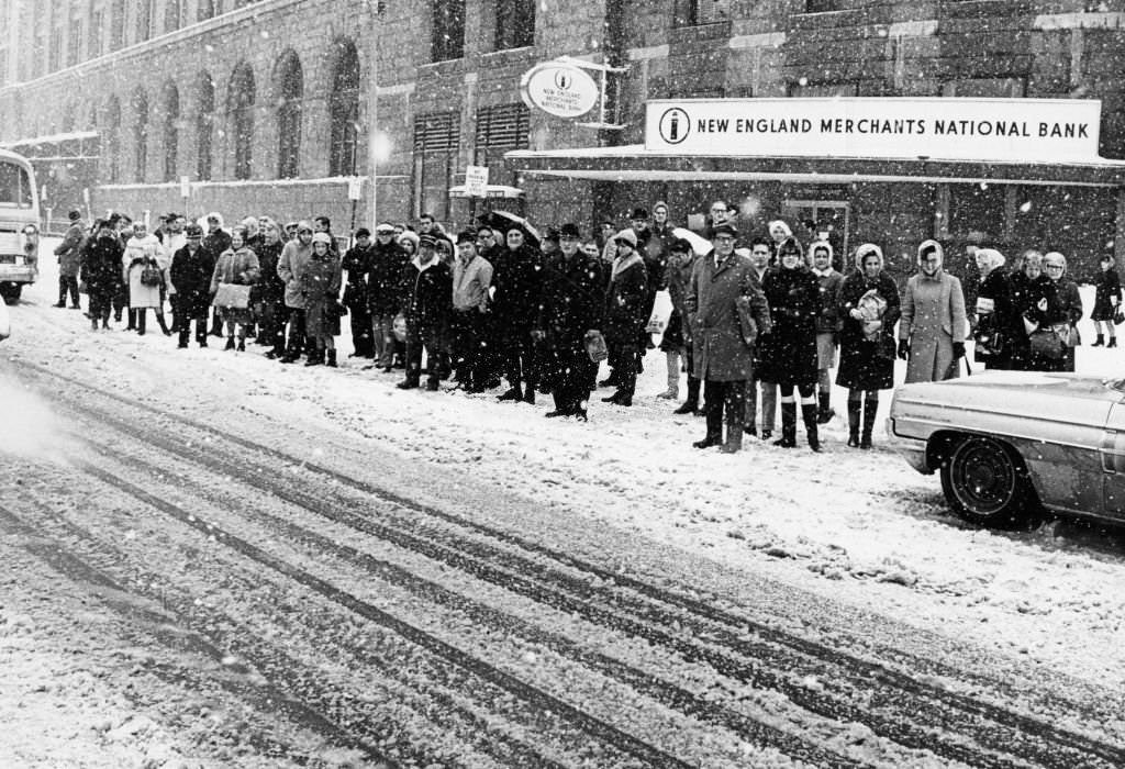 #234 Commuters wait in the snow outside South Station in Boston on March 2, 1969.