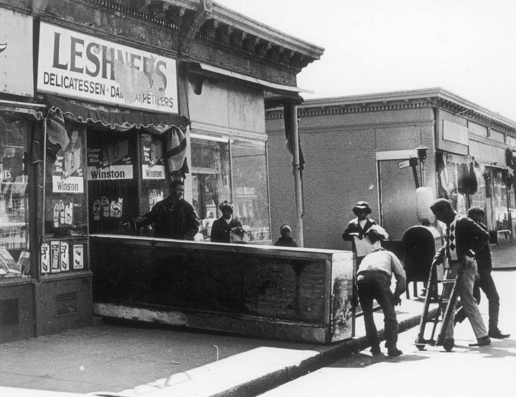 #244 Workers move a new counter into a store called Leshners Delicatessen on Blue Hill Avenue in Boston on May 4, 1969.