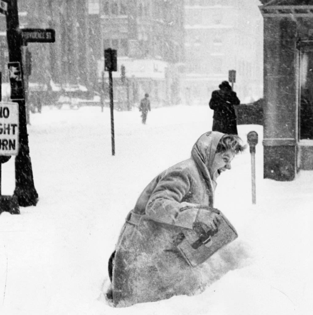 #63 A girl wades through a snow drift in Park Square in Boston, 1960.
