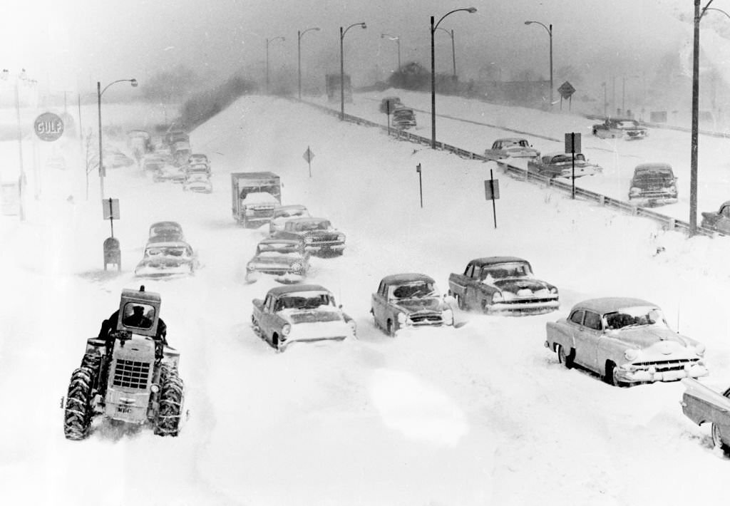 #64 Cars abandoned in the snow block the entrance to Morrissey Boulevard from Kosciuszko Circle in Boston at 3 p.m., 1960.