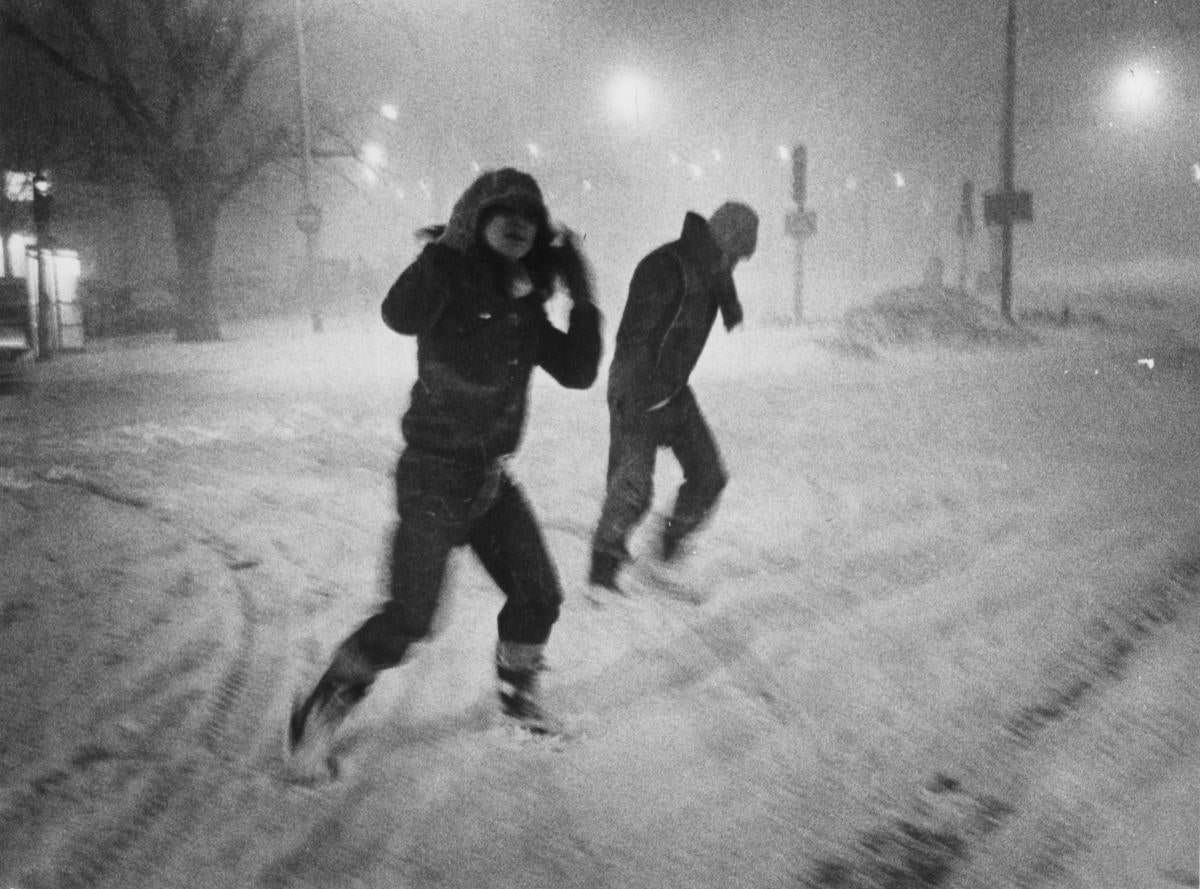 #13 Pedestrians braved the wind and snow of the blizzard while crossing Commonwealth Avenue in Boston on Feb 6.