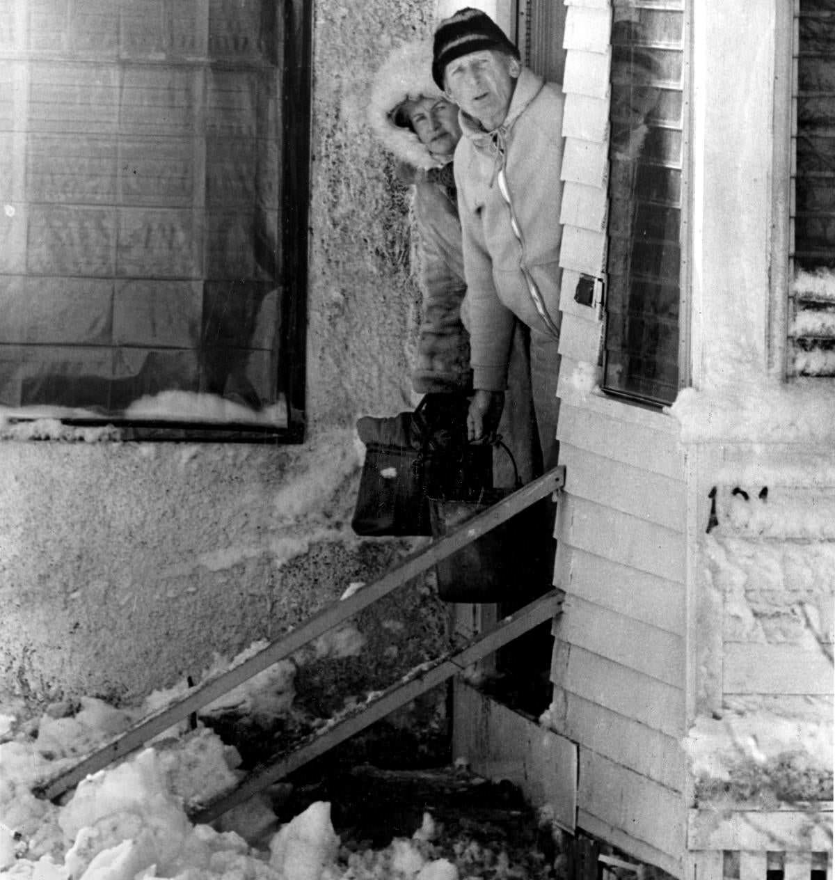 #31 A man and woman wait for a rescue team in Revere on Feb. 8.