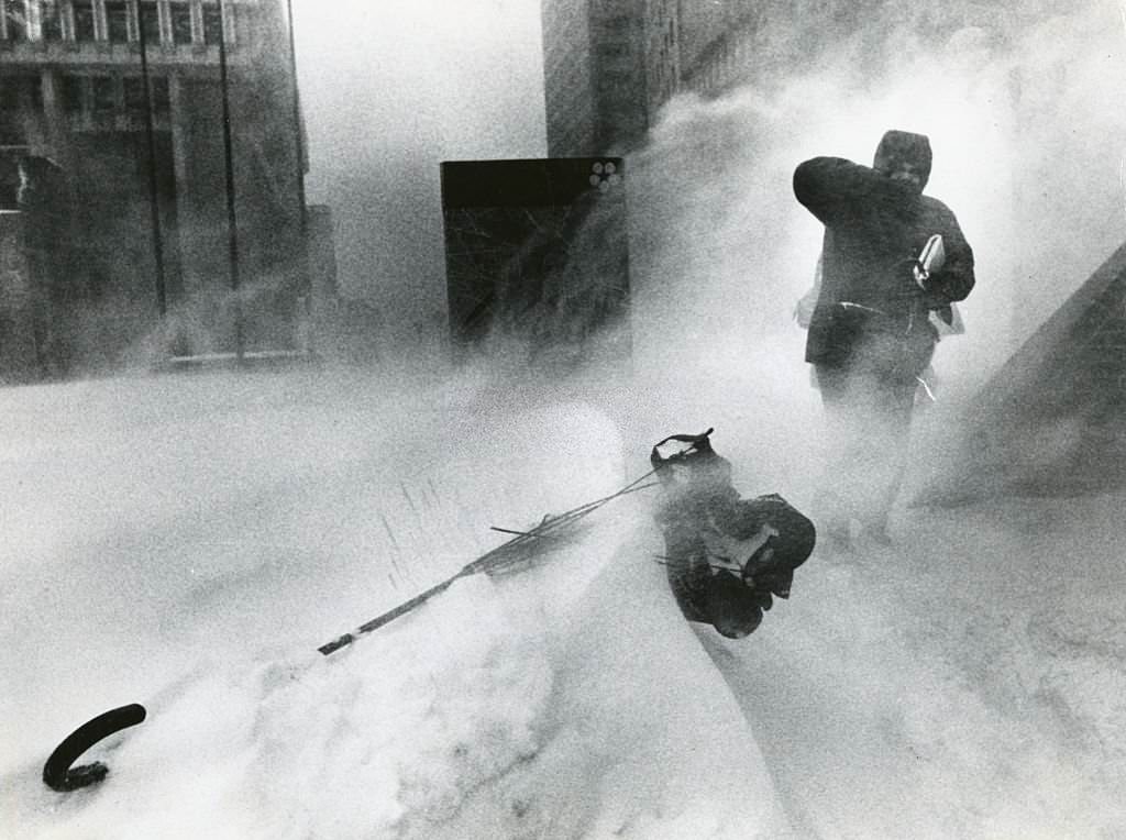 #34 A commuter fights his way to City Hall MBTA Station passed mangled umbrella during a storm in Boston, 1978.