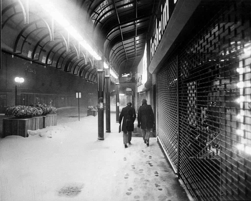 #46 People walk down Washington Street near Bromfield Street in Boston on Feb. 6, 1978, during a record-breaking blizzard.