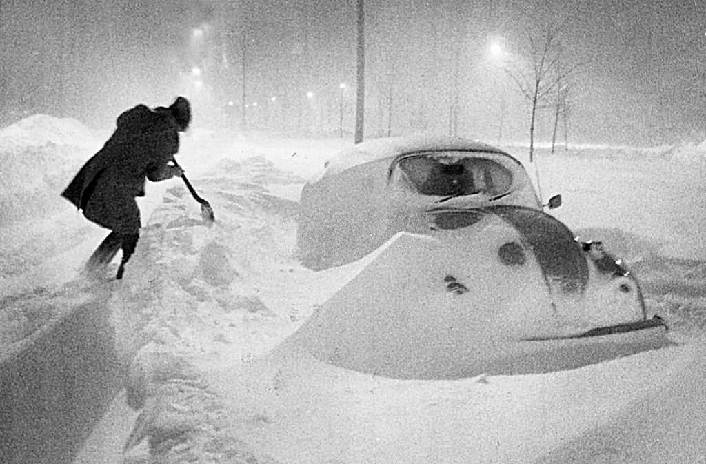 #54 Falling and drifting snow surrounds a car on Morrissey Boulevard during the early morning hours of Feb. 7, 1978.