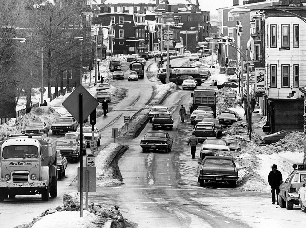 #123 Dorchester Street in South Boston is a wide street made narrow by snow and ice, 1977.