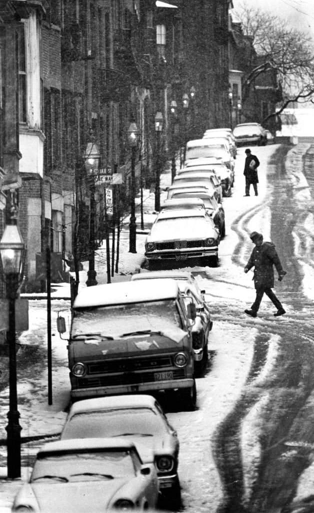 #129 A line of snow-covered cars is pictured along Pinckney Street in the Beacon Hill neighborhood of Boston, 1976.