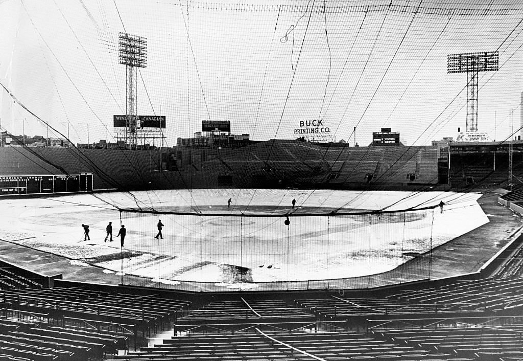 #134 The grounds crew clears yesterday’s snow off the playing field at Fenway Park in Boston, 1975.