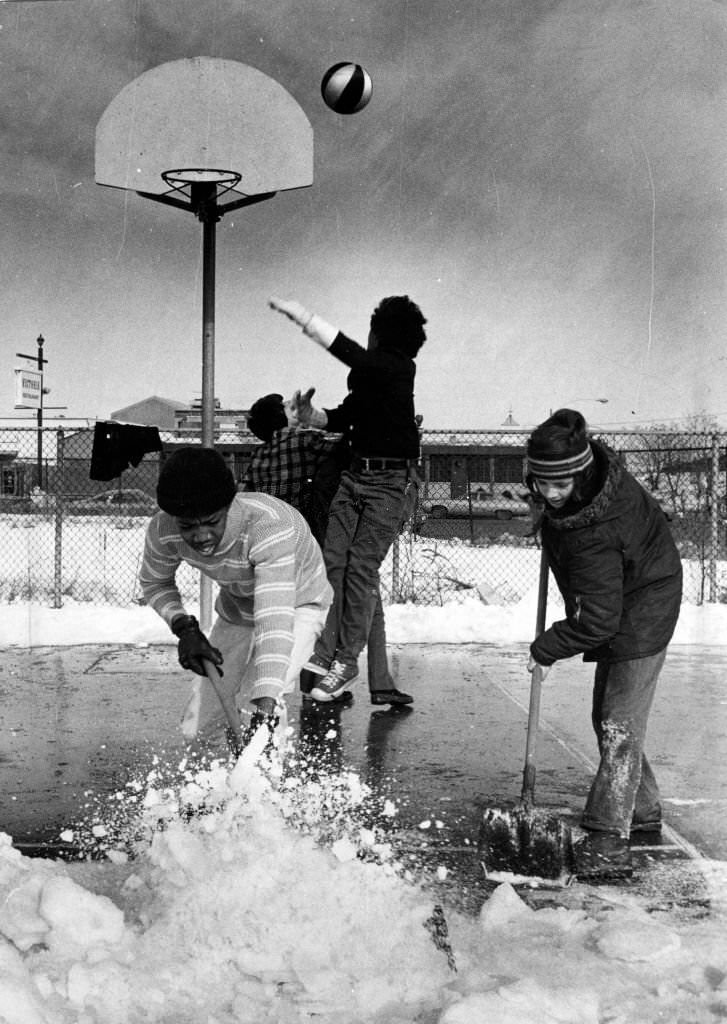 #135 Tony Blaides,15, and Robert Landry, 13, shovel snow away from basketball court in Eustis Park as their friends couldn’t wait for the rest of the area to be cleared after a winter storm, Feb. 7, 1975.