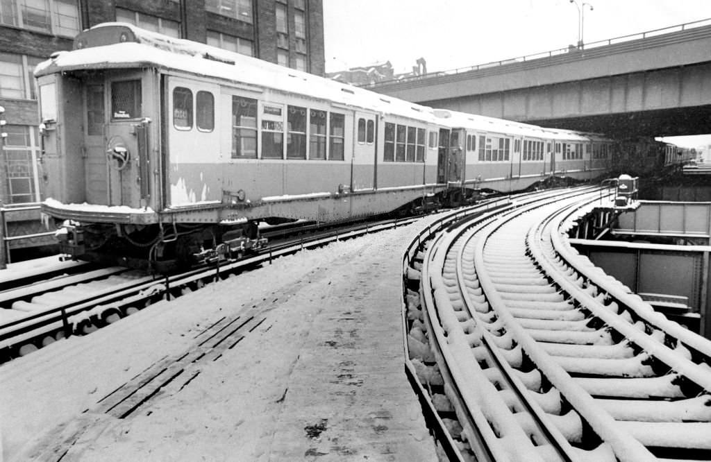 #156 An MBTA train is pictured in December 1970 in Boston after a snow plow derailed on the Forest Hills to Everett line, making it necessary to run shuttle buses between North Station and Sullivan Square.