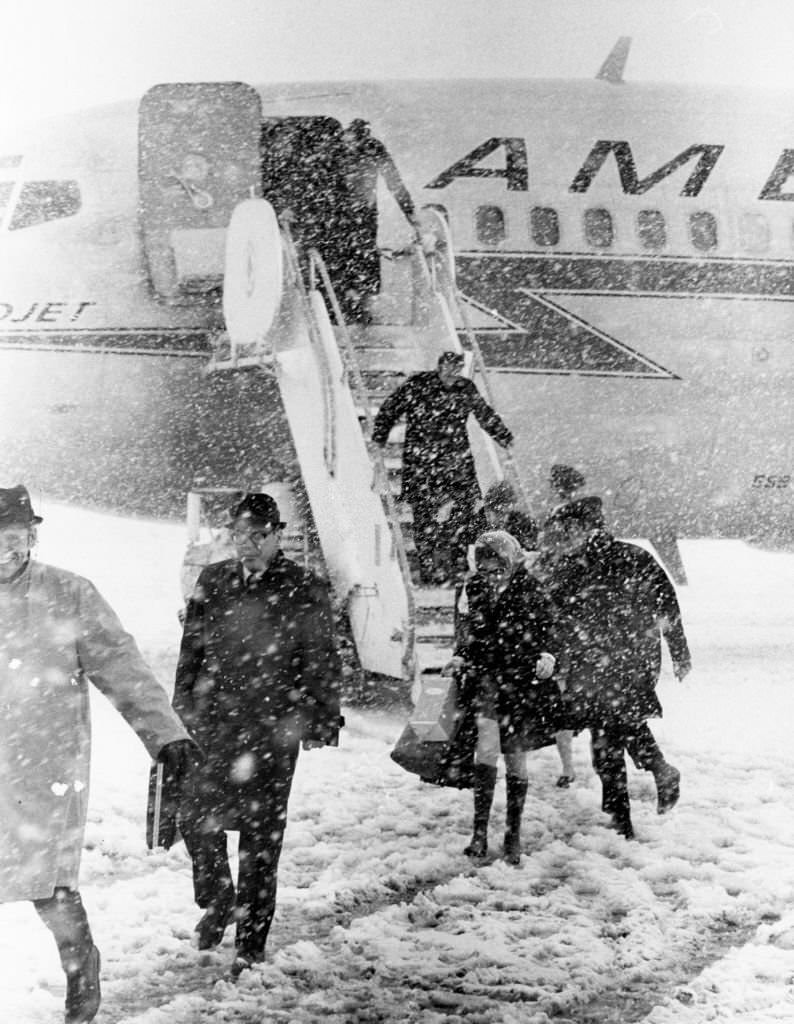 #175 The last load of passengers get off a plane in the snow at Logan International Airport in Boston, 1969.