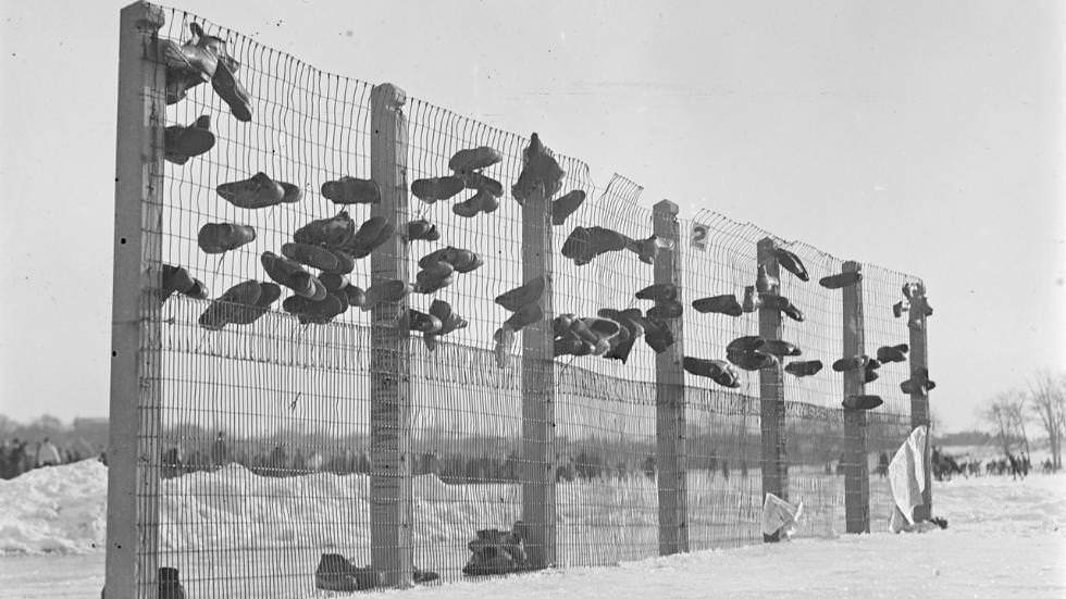 #22 Skaters put up shoes in baseball backstop at Franklin Field, 1933