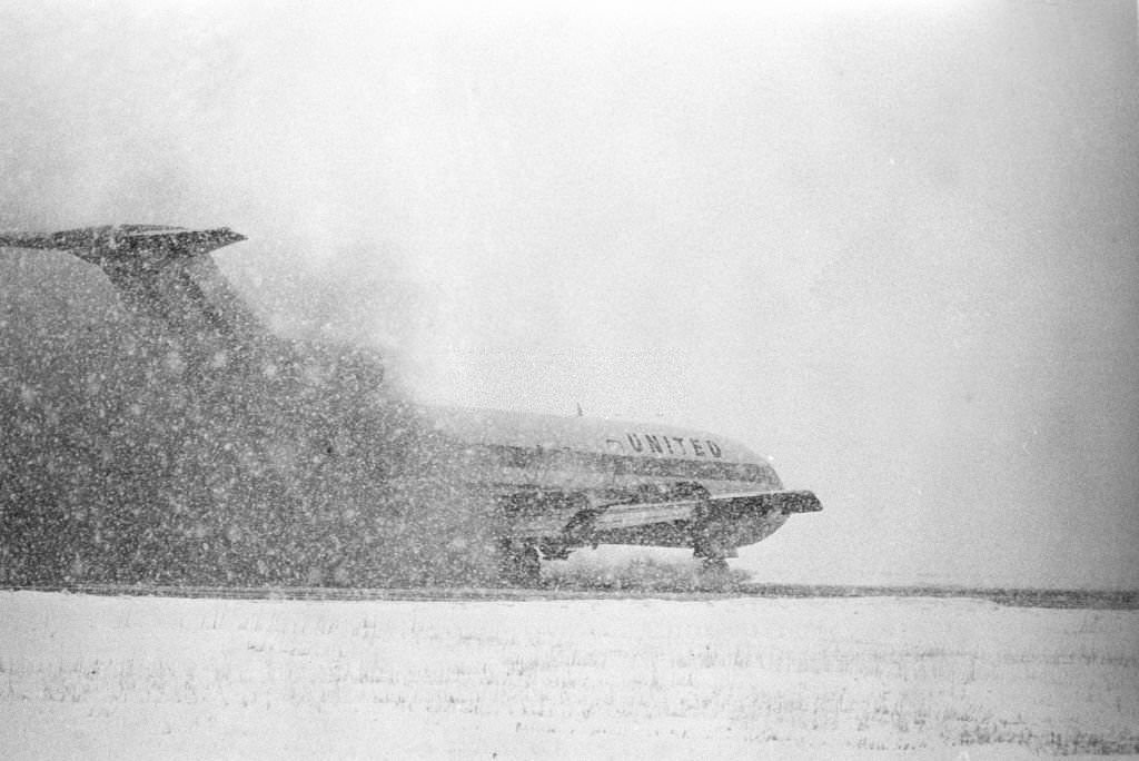 #36 An airliner comes in for a snowy landing at Logan International Airport, Boston, Massachusetts, 1969.