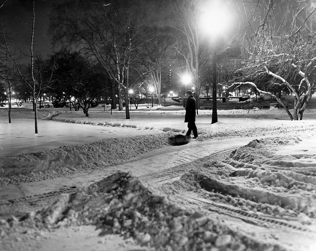 #50 A pedestrian walks through the snow in the Public Garden in Boston at 4 a.m. on Dec. 28, 1963.