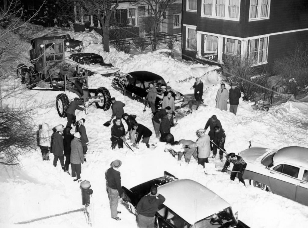 #60 People shovel snow on Everett Street in Dorchester in Boston, 1960, after a snowstorm.
