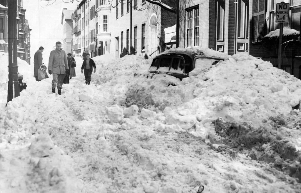 #65 People walk through the snow down the street in Boston on Mar. 20, 1956.