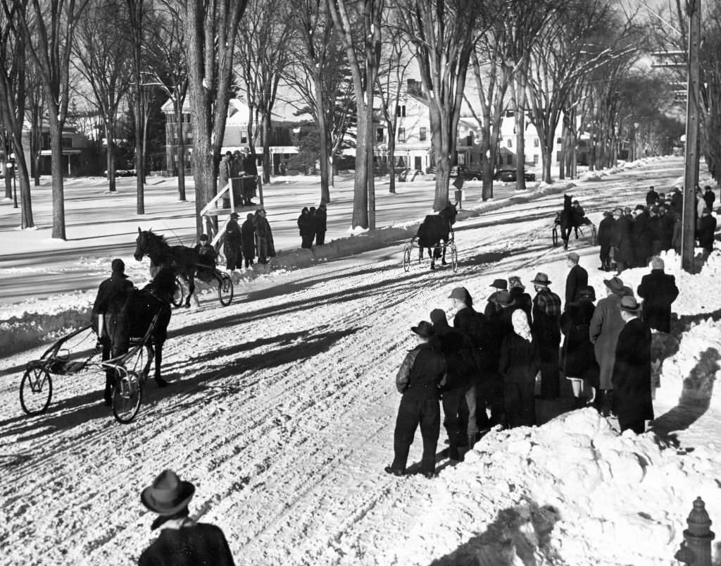 #76 Two horse-drawn carts race towards the finish line in Lyndonville, Vt., February 1946.