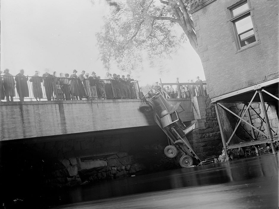 #17 Truck hangs by wheel off bridge, 1934