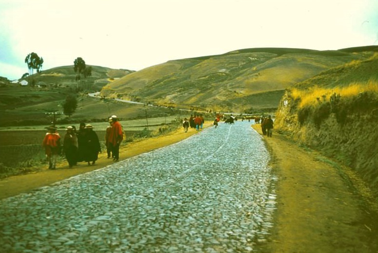 #19 Ecuador. People streaming into market in early morning. Many trot all the way (for miles) with loads on their backs, 1959