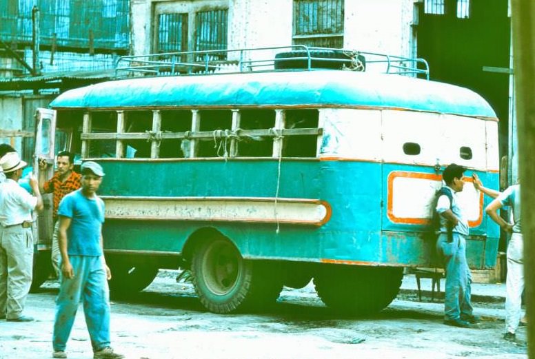 #1 Ecuador. Bus between Cuenca and Pasaje. People in front, cows in rear, chickens on top, 1959