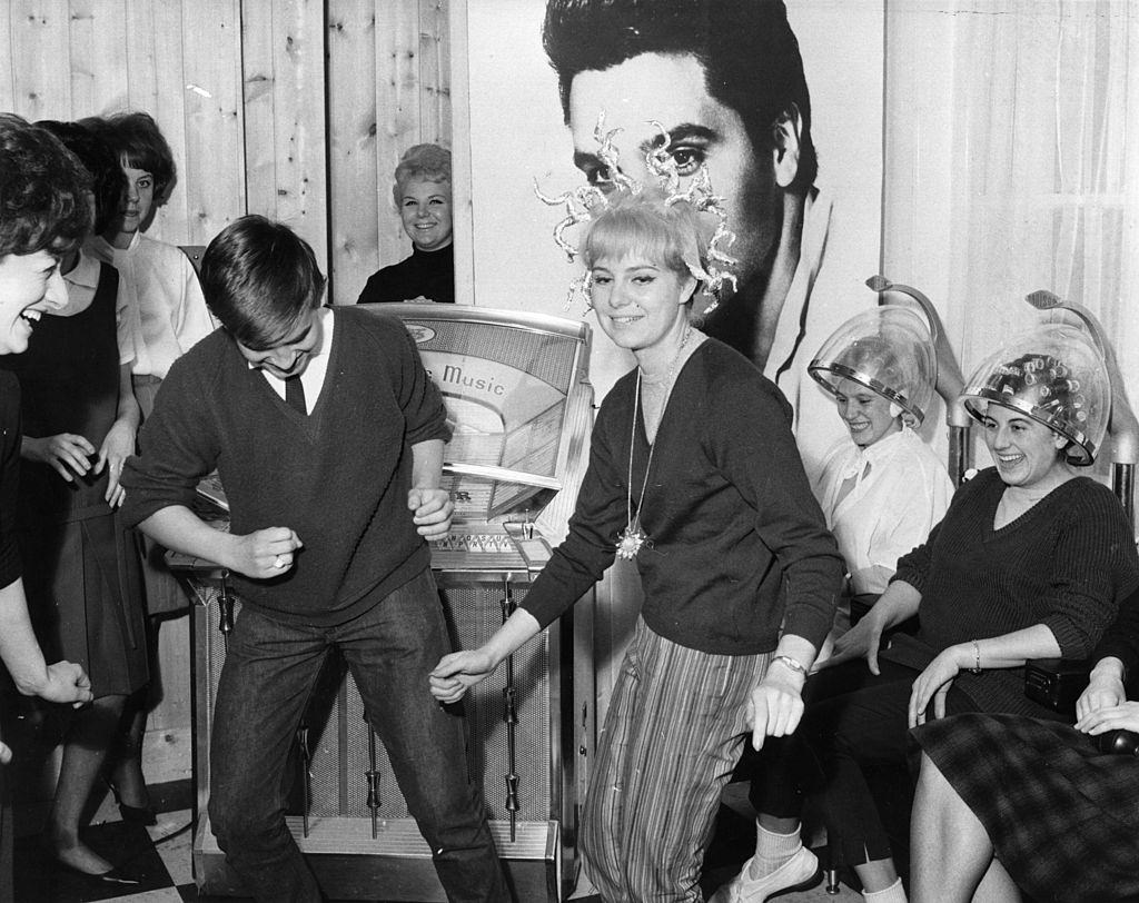 #25 Young people dancing at a hairdressing salon opened by John French at Egham, Surrey, which caters exclusively for teenagers, 1962