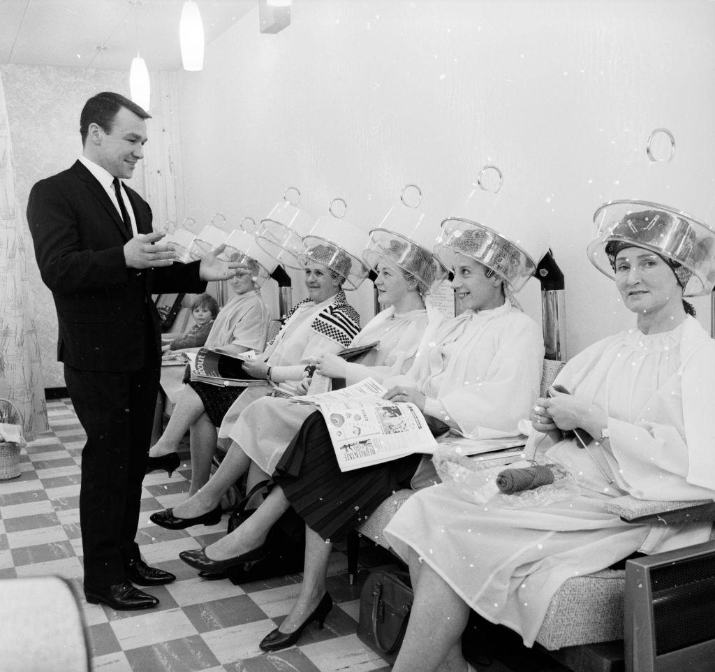 #26 European Lightweight boxing champion, Dave Charnley admiring his clientele at his hairdressing salon in Dartford, 1962