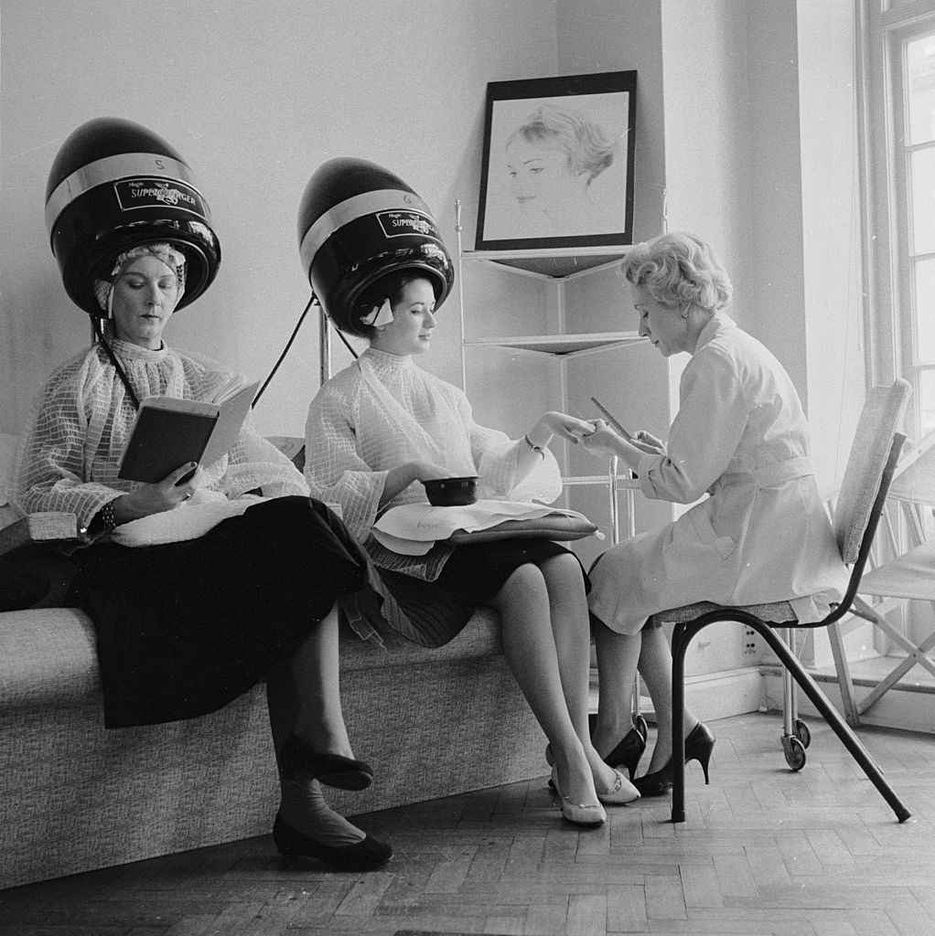 #33 Women enjoy a manicure and hair treatment at the John Douglas School in Mayfair, London, 1959.