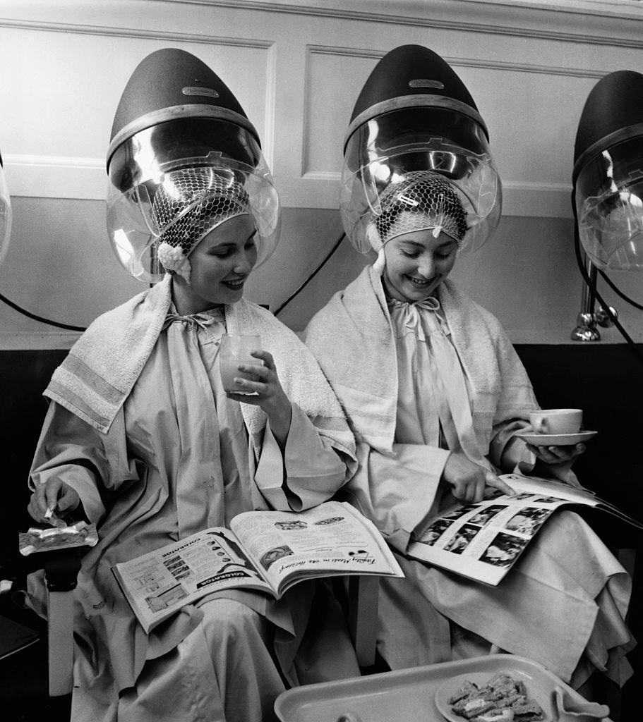 #54 Women relax as they sit under hair dryers at the Valentino & Rita of Knightsbridge beauty salon in London.