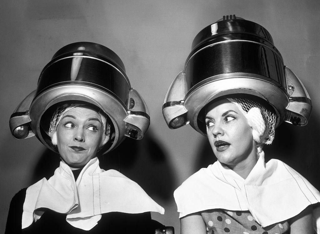 #63 Two women gossping under Hairdresser hair dryer, 1950s