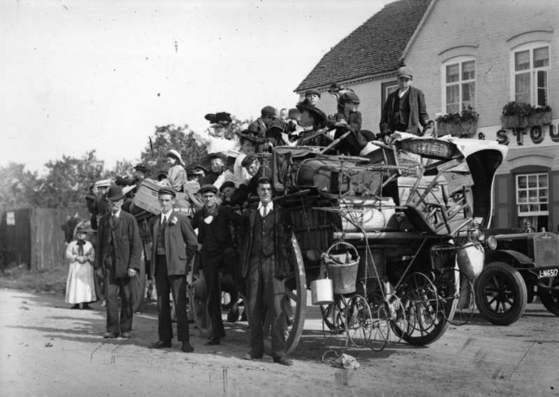 #5 A family of hop pickers stand beside their packed cart, 1907.