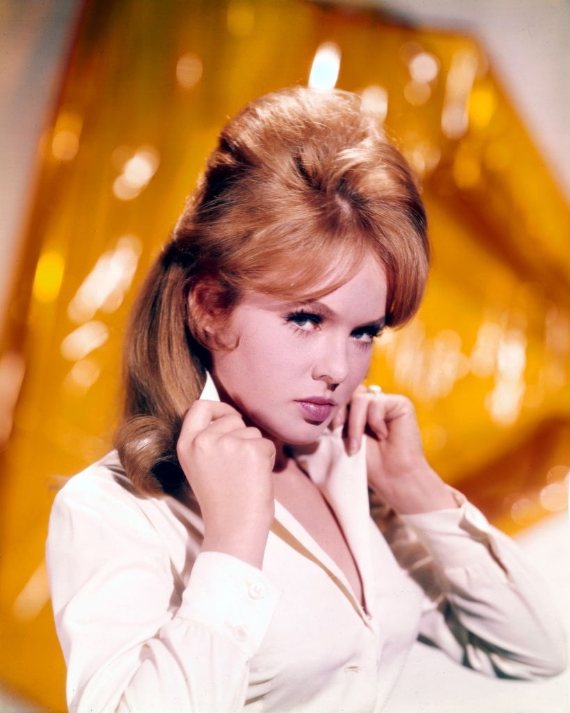 #16 Joey Heatherton poses holding the collar of her white blouse, 1965