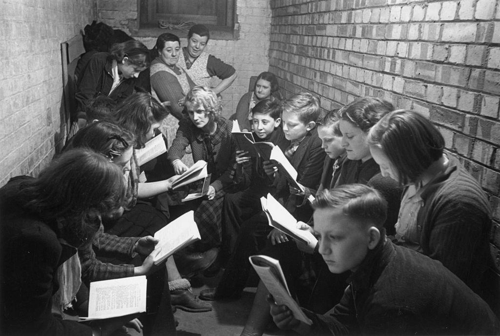 #1 A reading and discussion session in an air raid shelter in Bermondsey, south London, during the Blitz, March 1941.