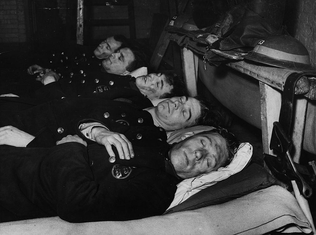 #3 After 12 hours fire fighting during the London blitz firemen enjoy a sleep but keep on their uniform.