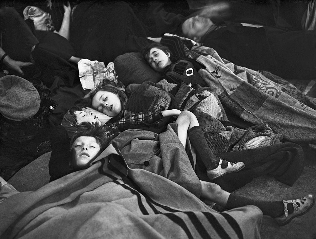 #8 Children sleeping on a platform at a London Underground station, where they have taken shelter during one of the nightly bombing raids of the London Blitz,18th October 1940.