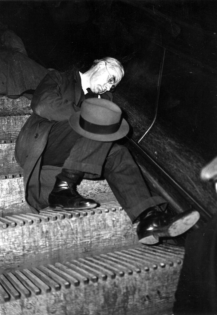 #13 A man sleeping on an escalator in an underground station in London during an air raid.