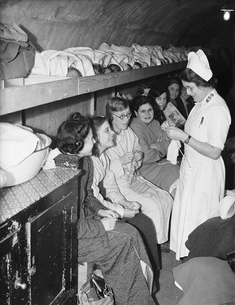 #24 Women, girls and babies (lying on a shelf, top) in an air raid shelter run by the Salvation Army in Clapton, east London, during the London Blitz, 5th October 1940.