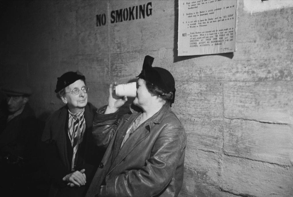 #43 Two women in an air raid shelter during the Blitz, London, October 1940.