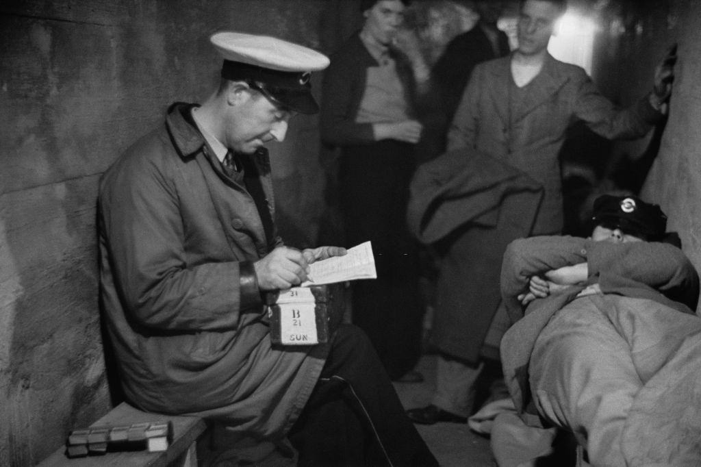 #44 A group of people in an air raid shelter during the Blitz, London, October 1940.