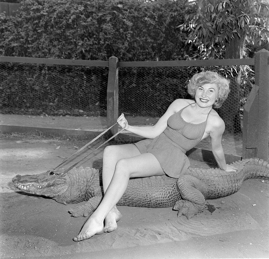 #1 A model poses as she rides an alligator at the Los Angeles Alligator Farm at 3627 Mission Road in the Lincoln Heights area of Los Angeles, California.