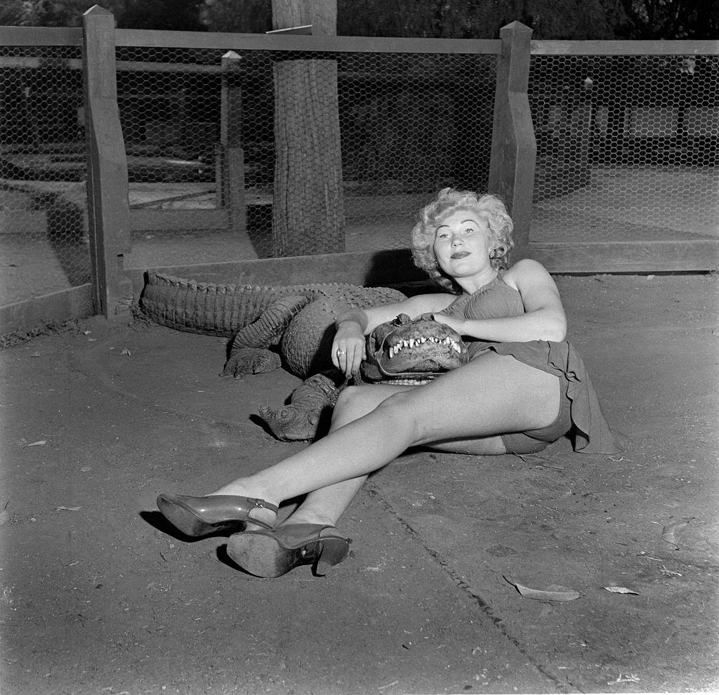 #14 A model poses with an alligator at the Los Angeles Alligator Farm.